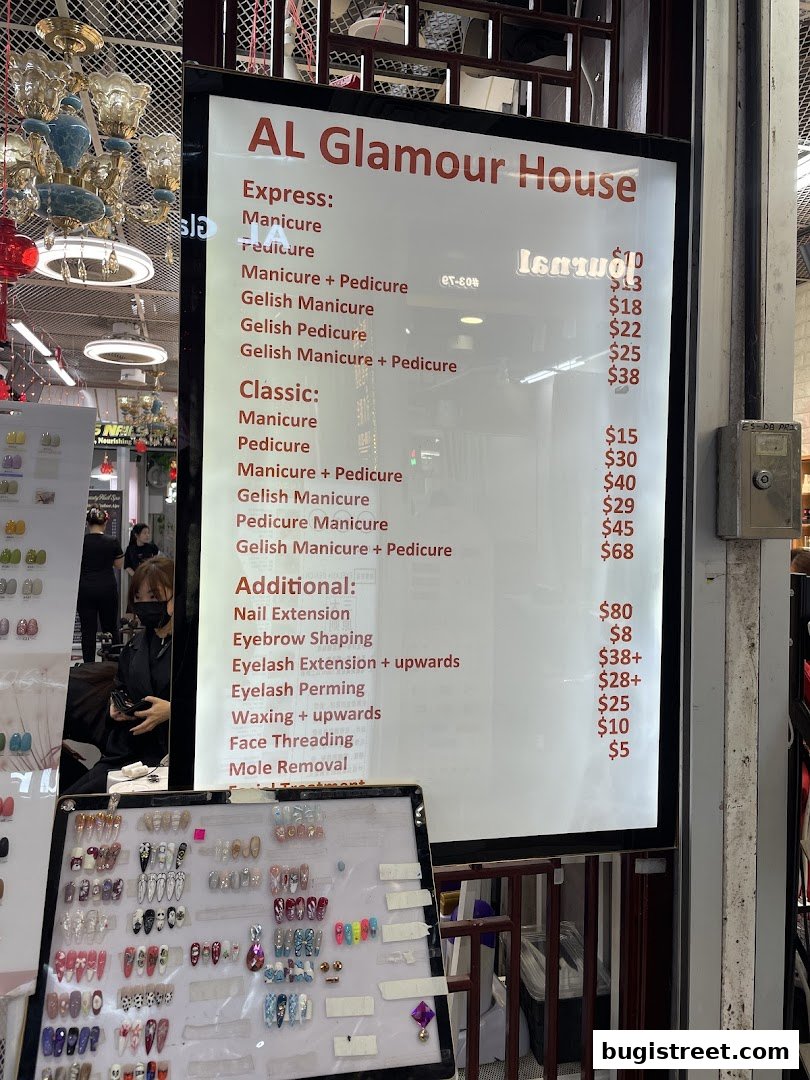 A menu board for Al Glamour House, displaying various nail and beauty services with prices.