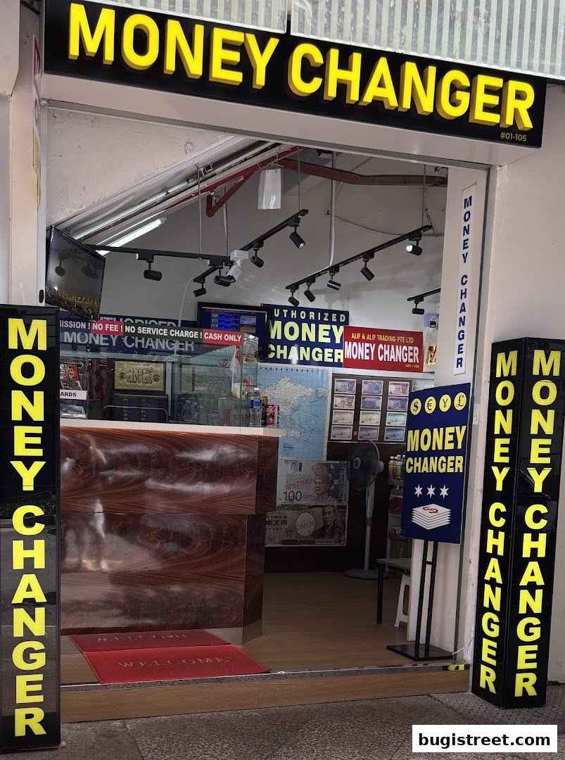 The entrance of Alif and Alif Trading Pte Ltd, a money changer shop with prominent signage.