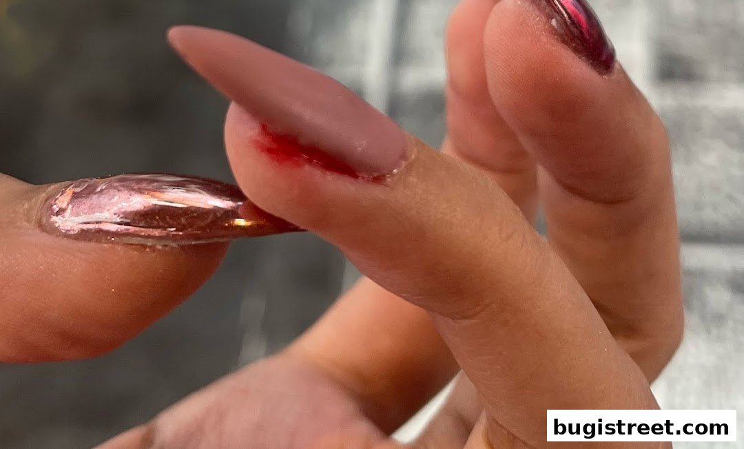 Close-up of a hand with beautifully manicured nails, showcasing intricate nail art and polish.