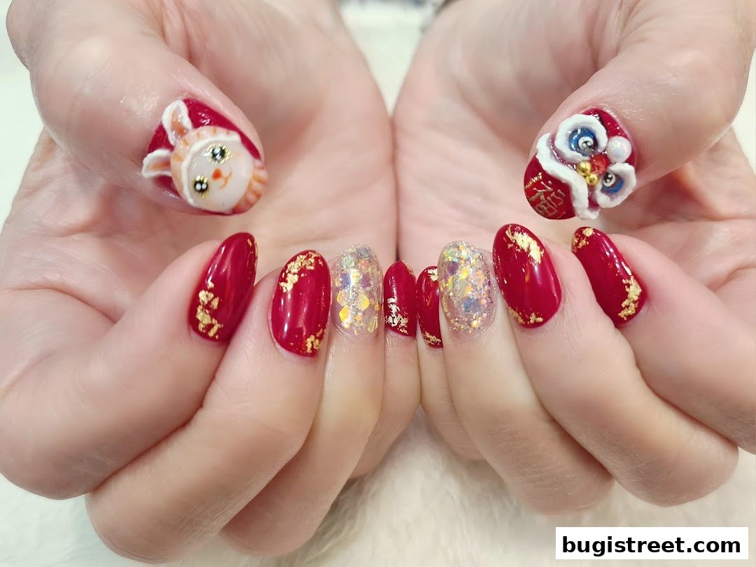 Close-up of hands with festive red and gold nail art, featuring 3D character designs.