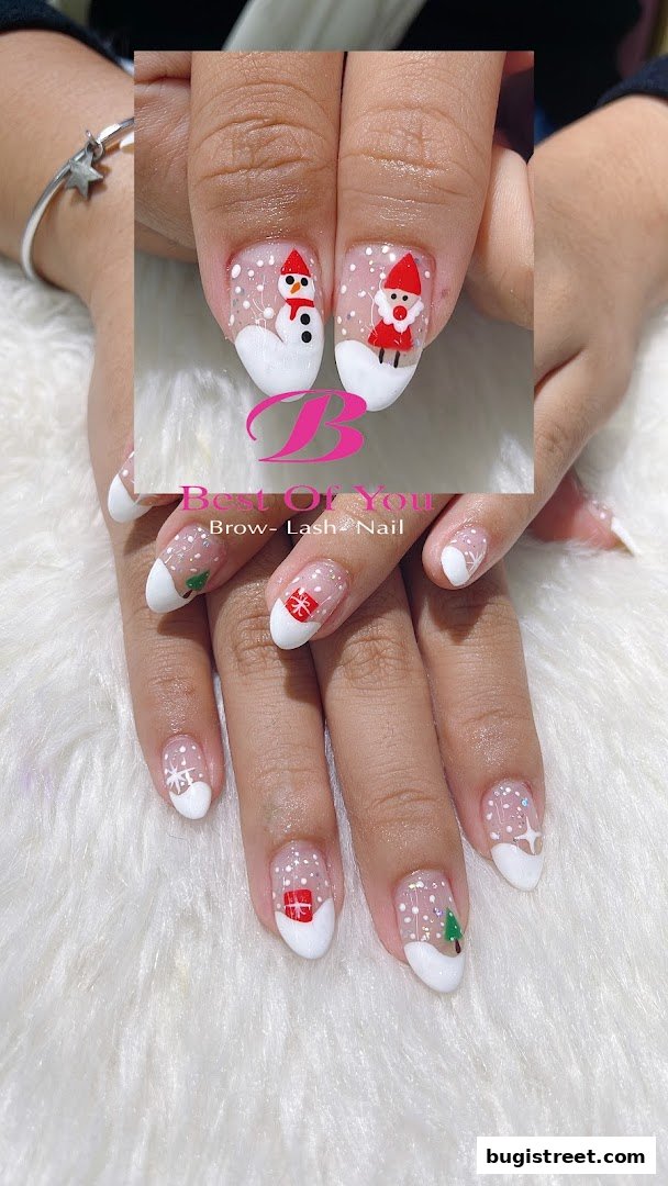 Close-up of hands with festive Christmas-themed nail art, featuring snowmen, Santa, and gifts.