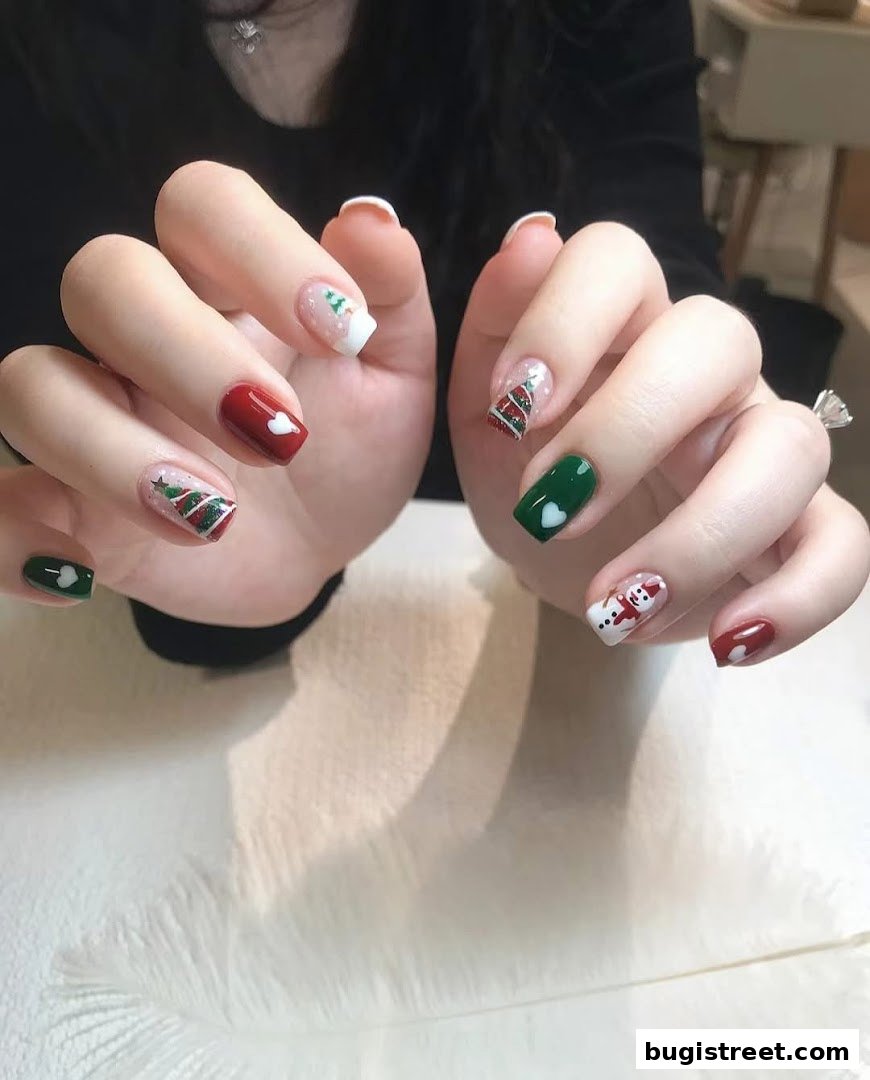 A close-up of hands with festive Christmas-themed nail art, including snowmen and trees.
