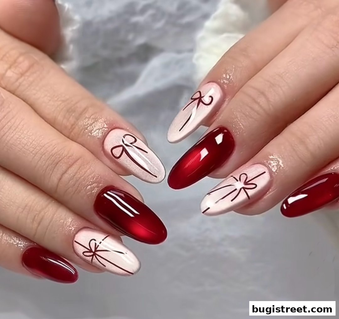 Close-up of hands with elegant red and white nails featuring delicate bow designs.