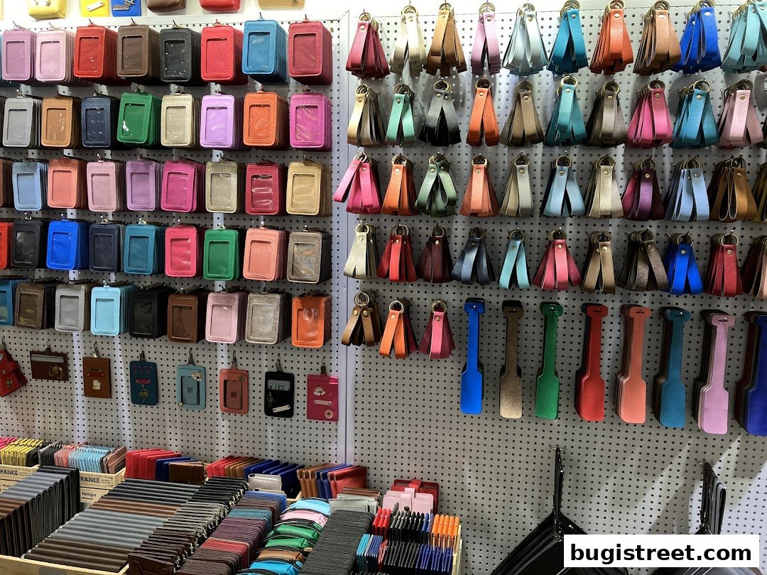 A wall display showcasing a wide variety of colorful leather cardholders and keychains.
