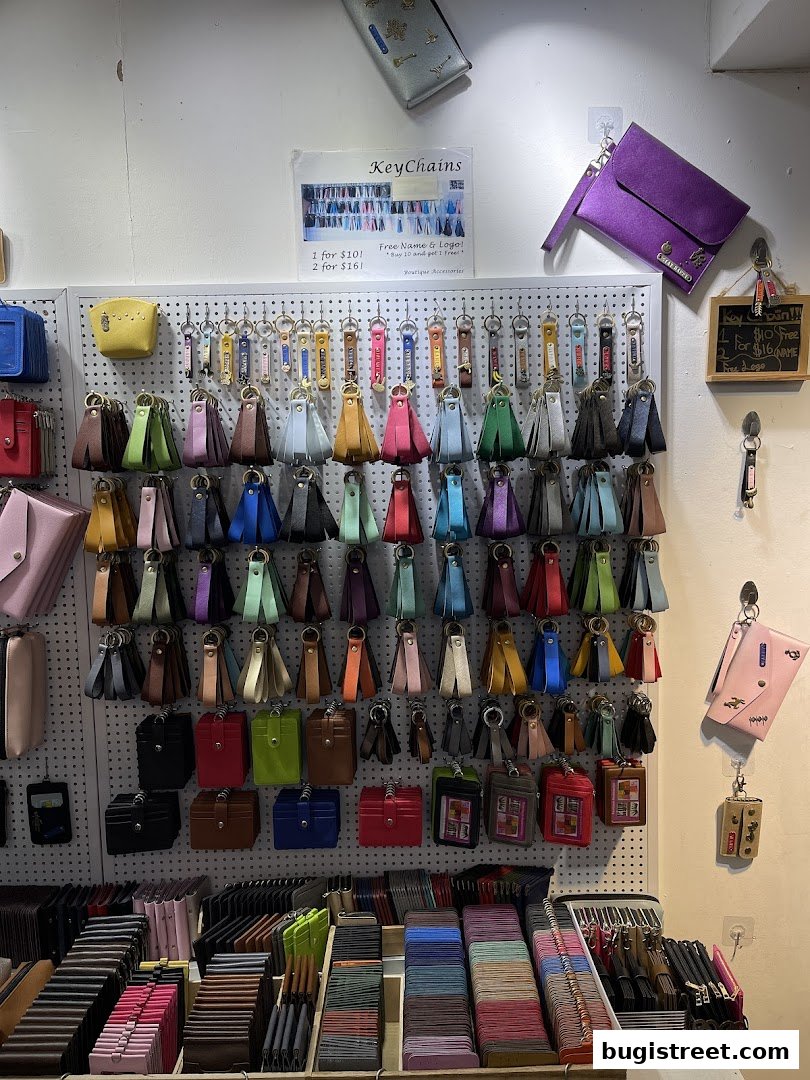 A wall display of colorful keychains and wallets at Boutique Accessories.