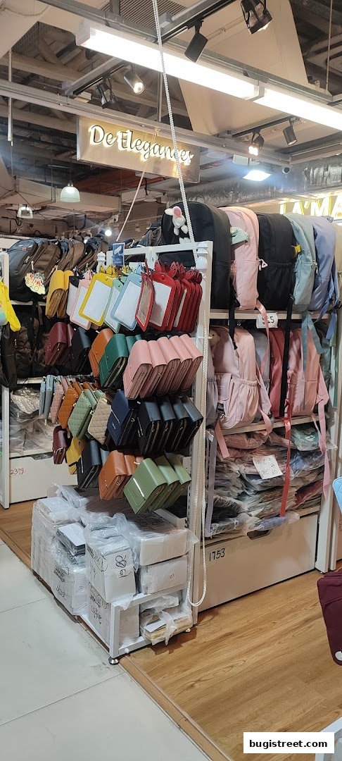 A shop interior displaying a variety of colorful backpacks and wallets.