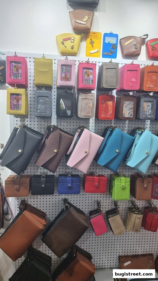 A wall display showcasing a variety of colorful wallets, cardholders, and pouches.