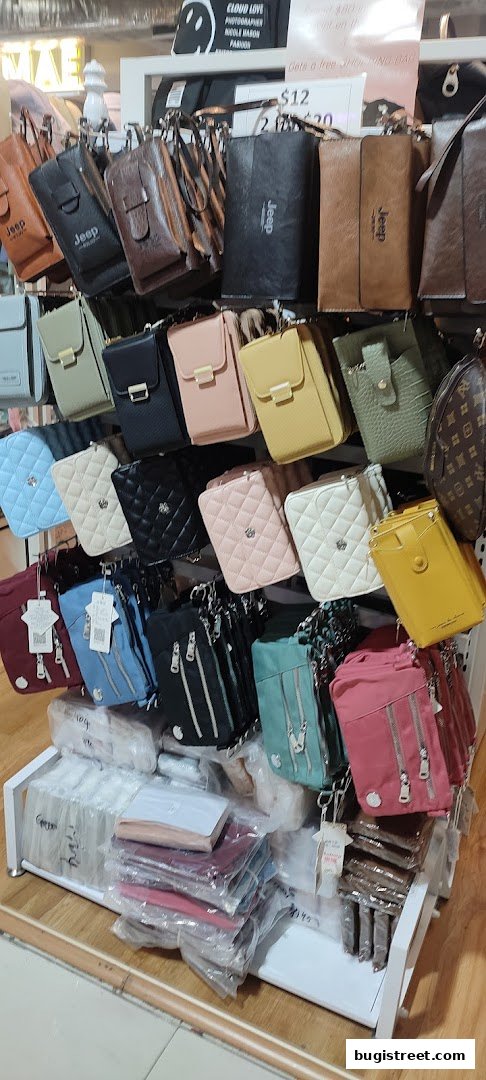 A display of various handbags and wallets in different colors and styles.