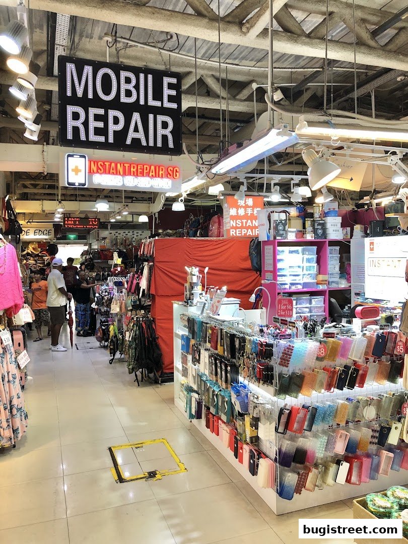 A shop interior with a prominent 'MOBILE REPAIR' sign and displays of phone accessories.