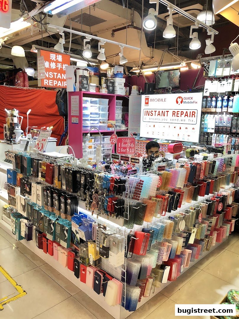 A brightly lit shop selling phone accessories and offering instant repair services.