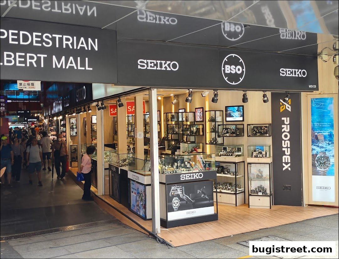A BSO Watch shop displaying Seiko and Citizen watches with a 'Pedestrian Albert Mall' sign above.