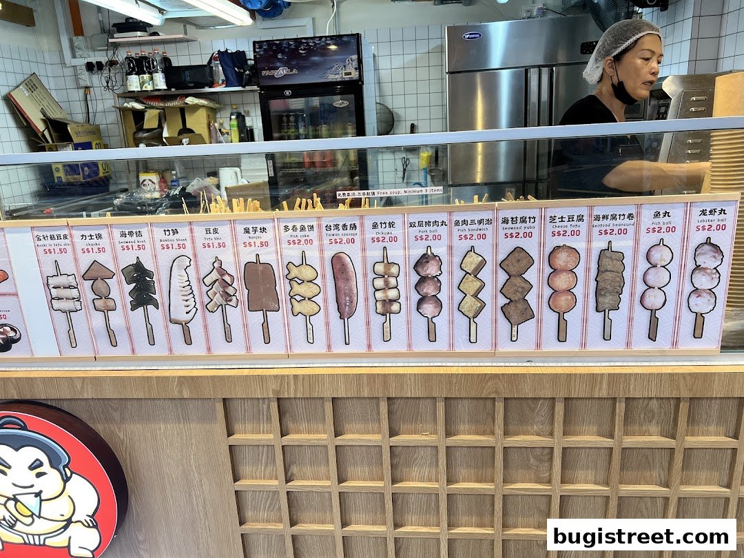 A display of various skewers with their names and prices at Chanko Oden.