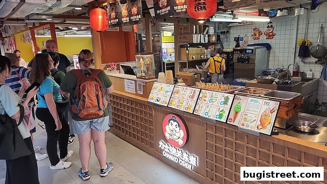 Customers queue at a food stall with colorful menus displaying various food items and ice cream.
