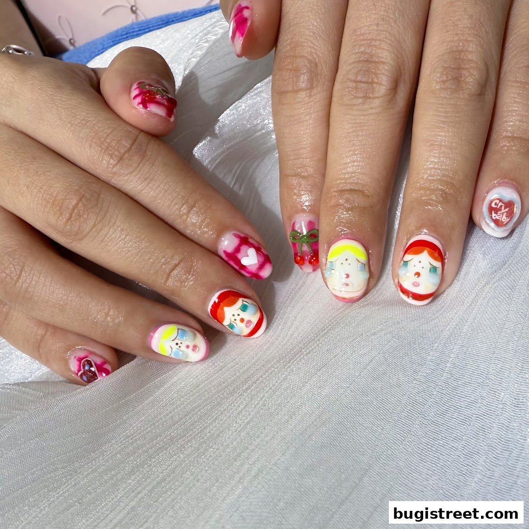 Close-up of hands with intricate nail art featuring cartoon characters and cherries.