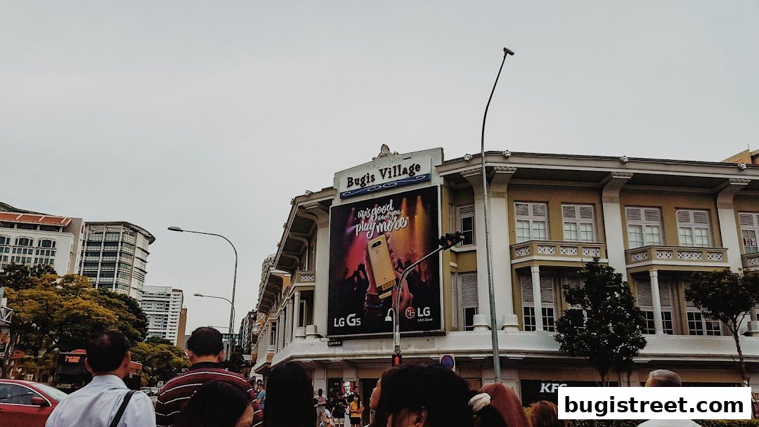 A street view of Bugis Village with a large LG G5 advertisement and a KFC outlet.
