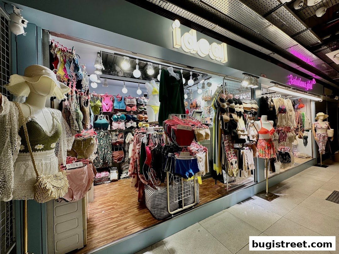 A brightly lit boutique shop displaying a variety of women's apparel and accessories.