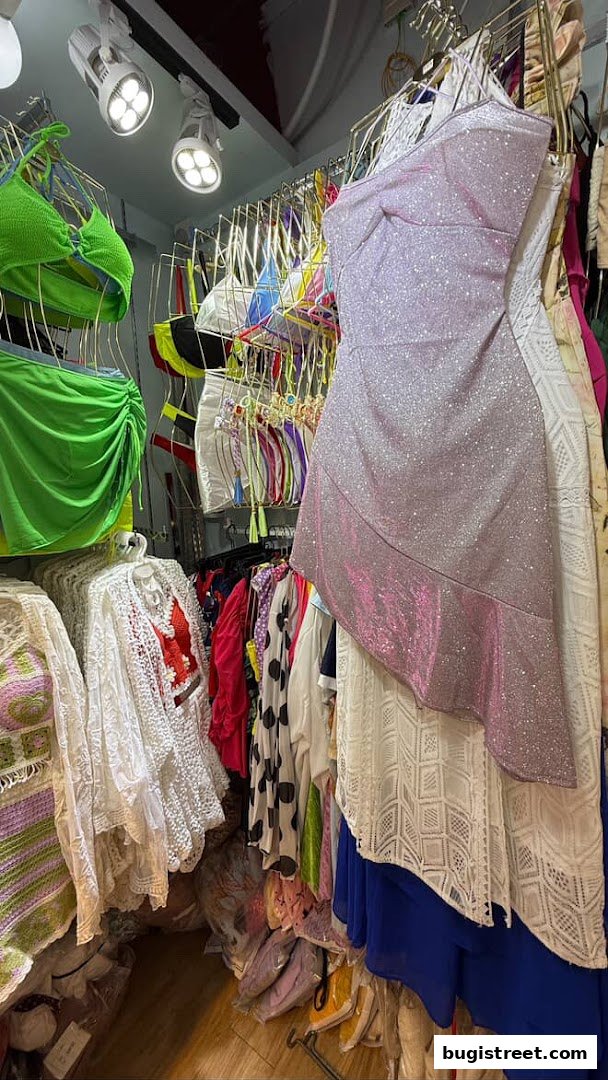 A vibrant display of women's clothing, including dresses, swimwear, and cover-ups.