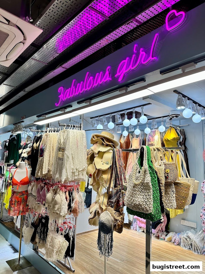 A boutique shop displaying summer fashion items like swimwear, hats, and bags.
