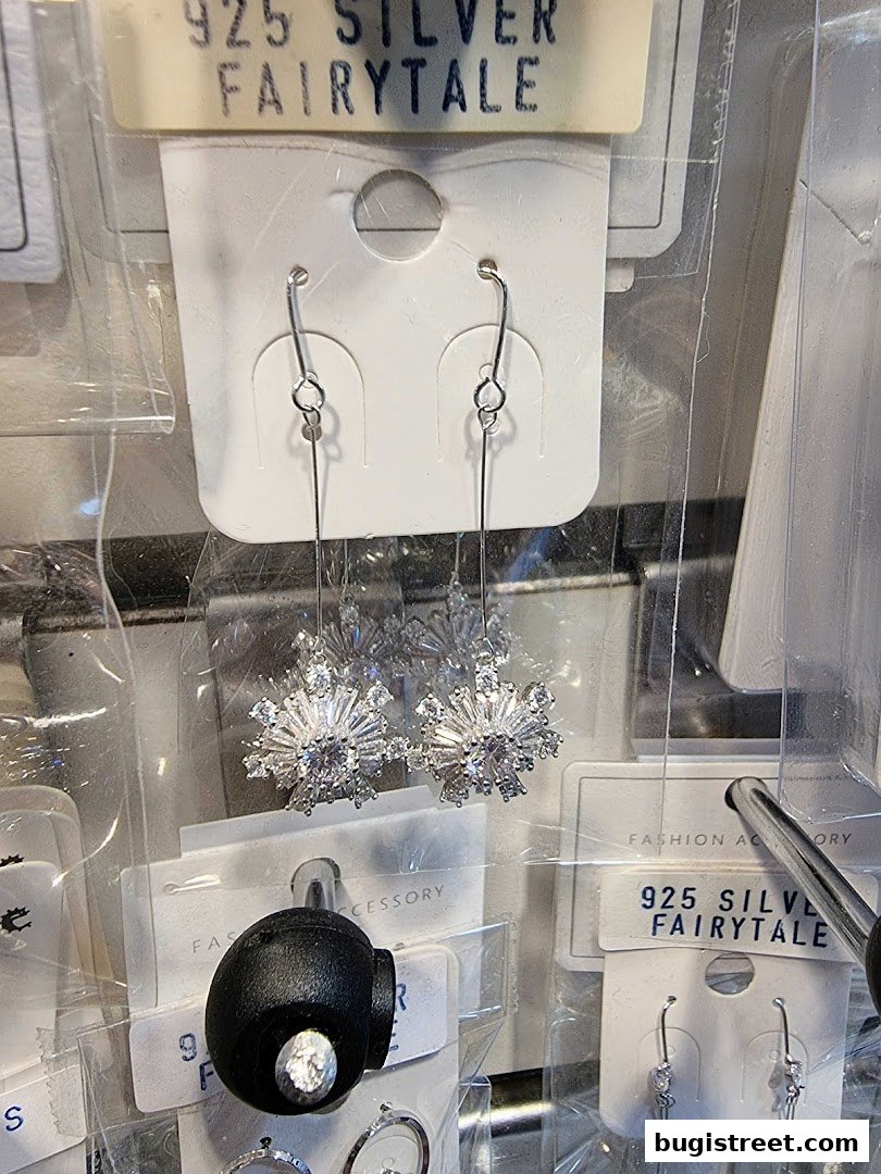 Close-up of sparkling snowflake-shaped earrings from the Fairytale jewelry store.