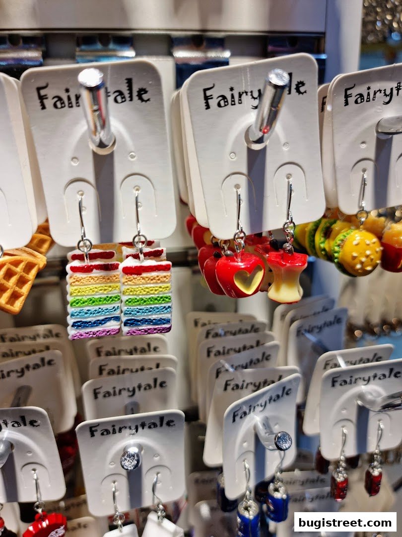 A display of novelty earrings shaped like food items and other fun designs.