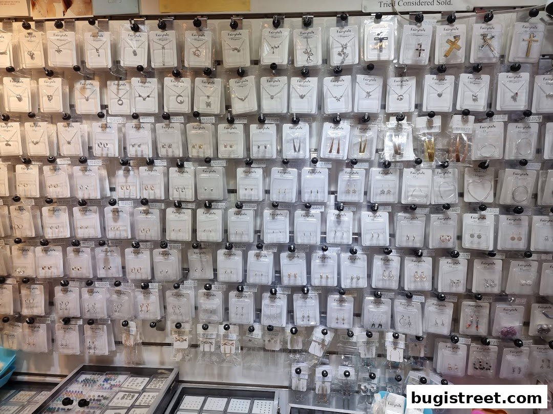 A wall display showcasing a wide variety of packaged jewelry, including necklaces and earrings.