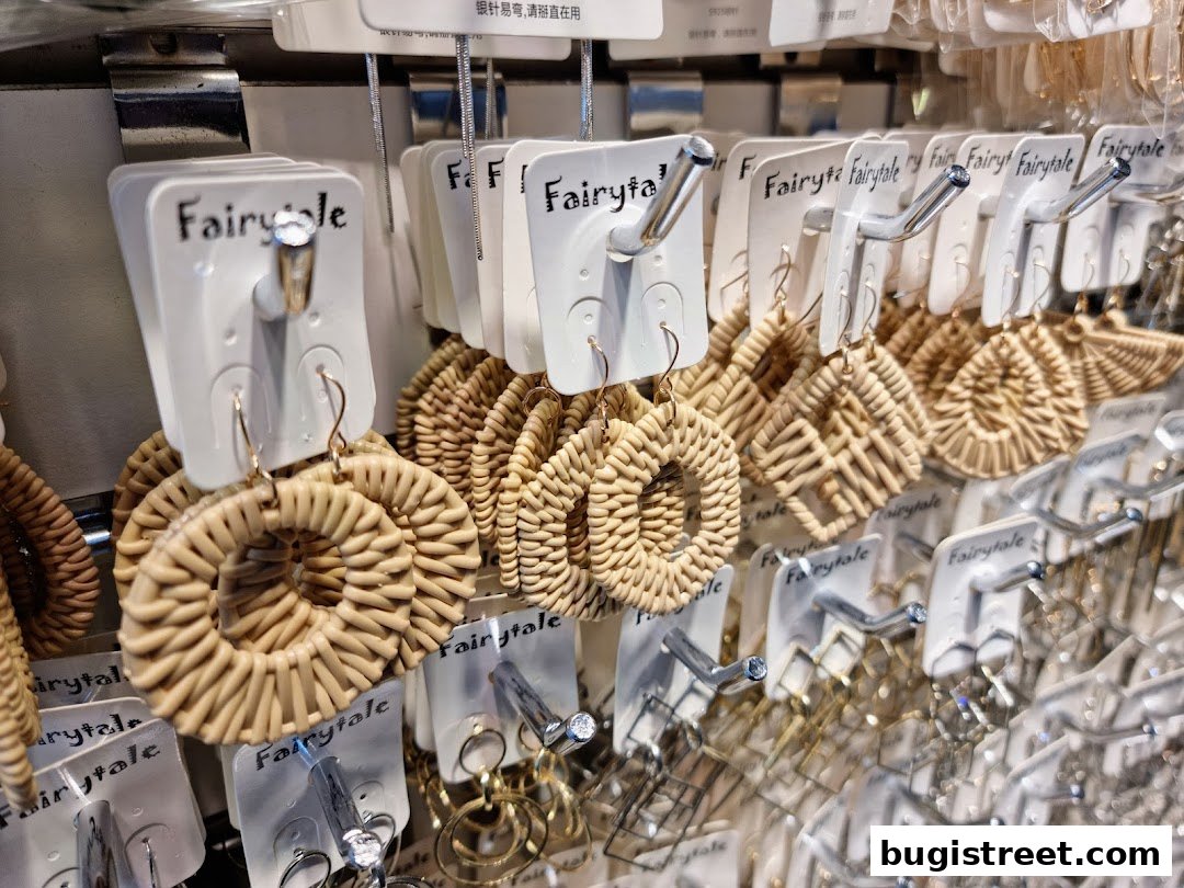 A display of various woven and metal earrings from the shop 'Fairytale'.