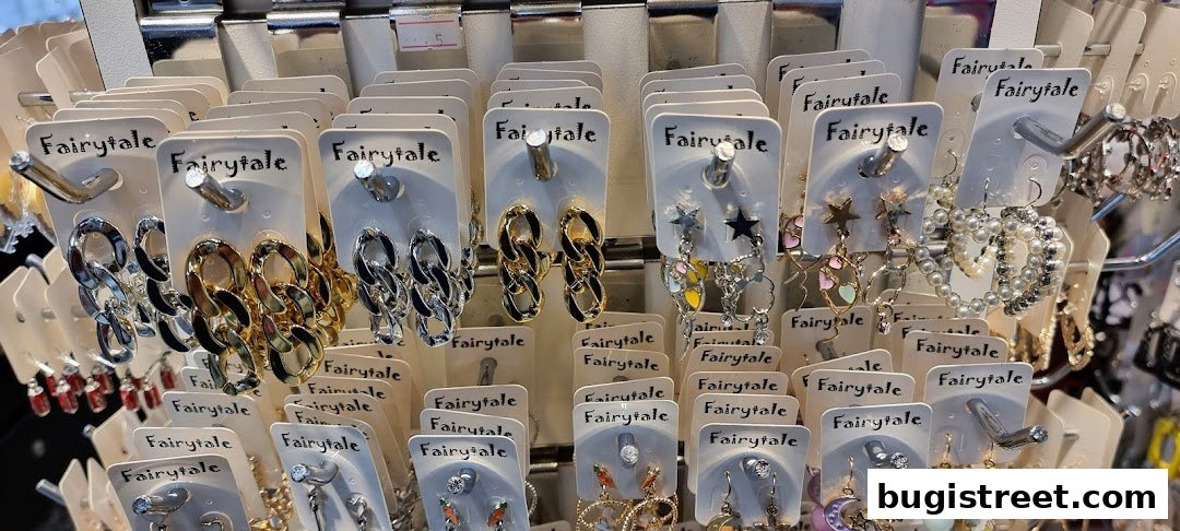 A display of various earrings, including chain link, star, and pearl designs, from the shop 'Fairytale'.