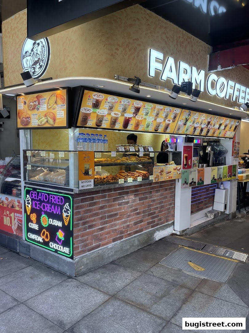 Farm Coffee shop with a display of drinks, fried items, and a neon sign for gelato.