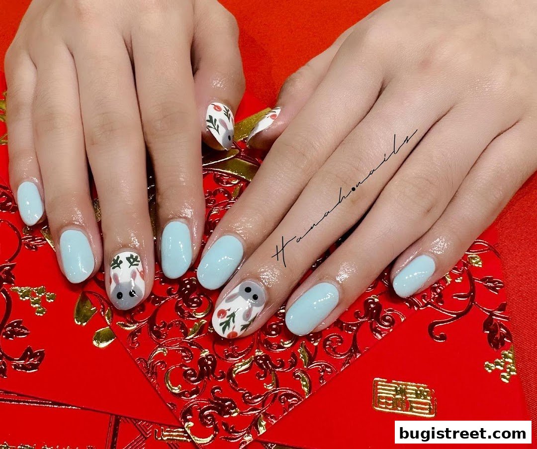A close-up of hands with light blue and bunny-themed nail art on a red background.