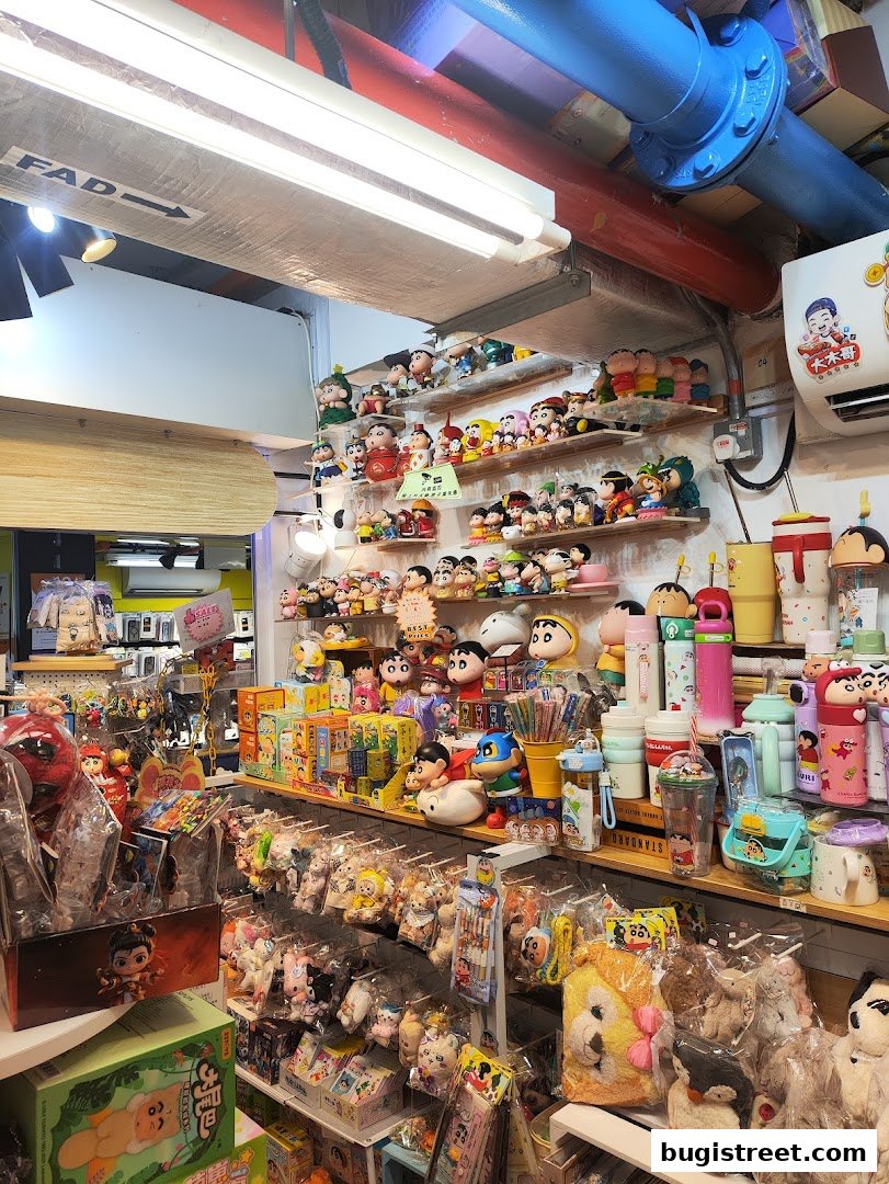 A retail shop interior filled with shelves of anime figurines, plush toys, and novelty items.