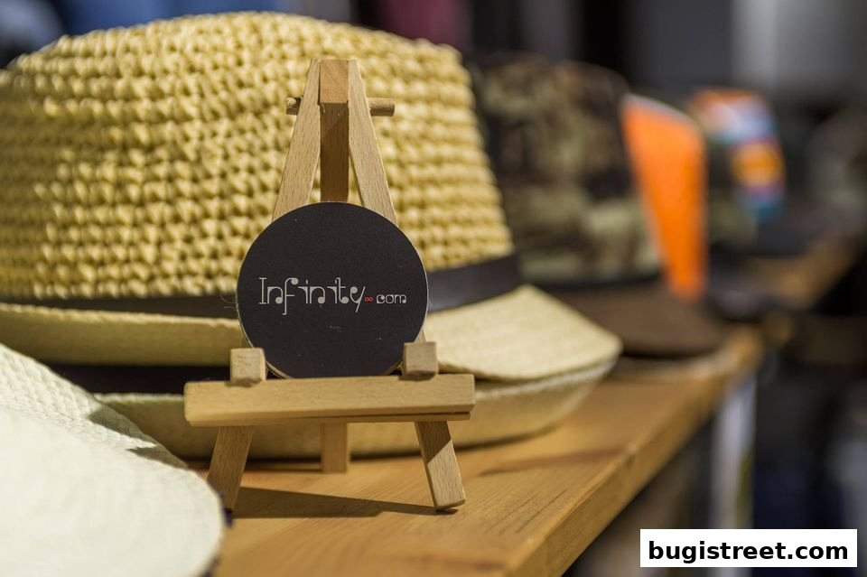 A close-up of straw hats on display with the shop's logo.