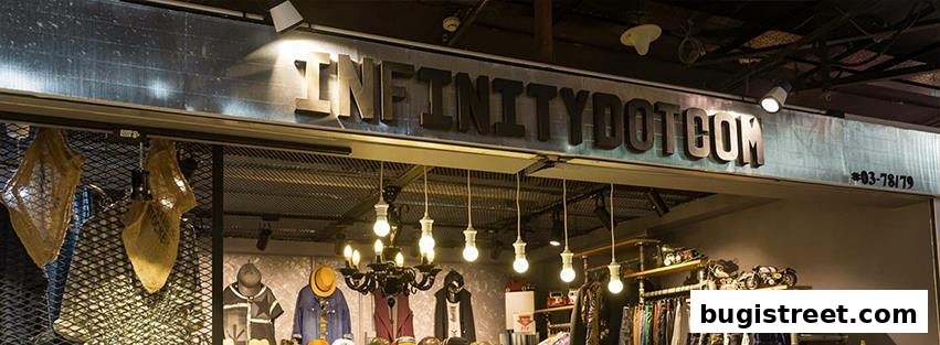The exterior of the Infinity clothing store with a prominent sign and display of apparel.