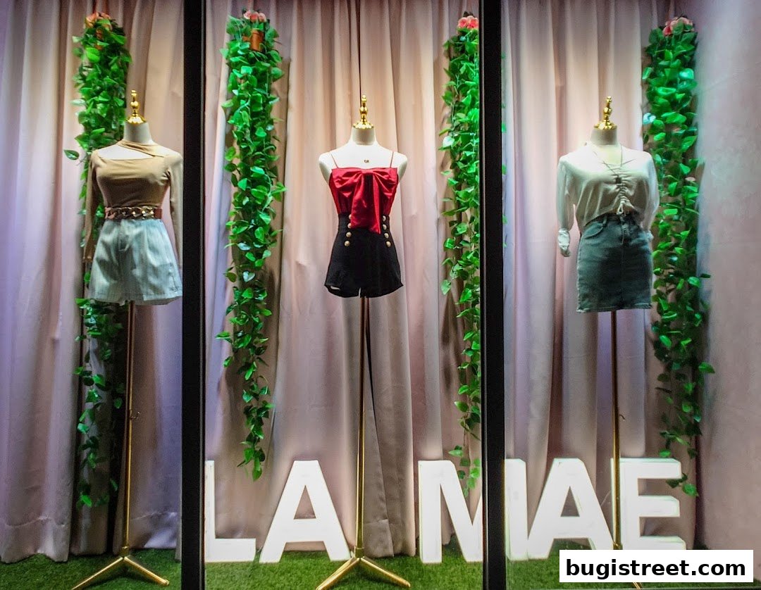 La Mae Boutique window display featuring three mannequins showcasing stylish outfits.