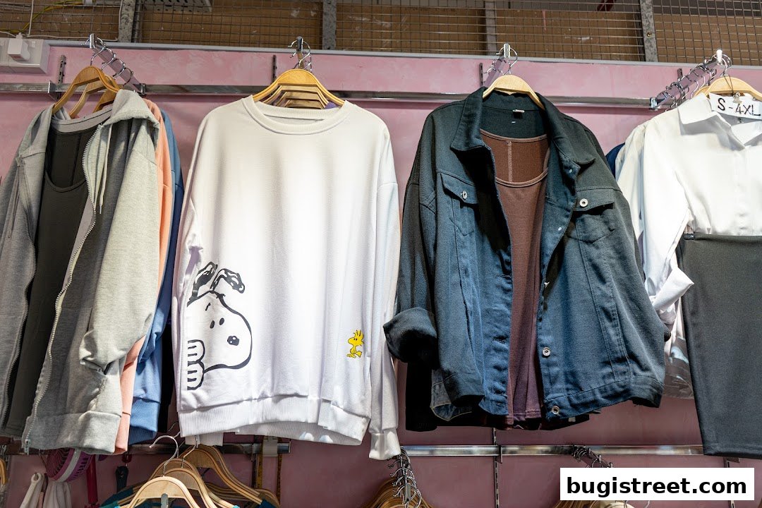 A selection of casual women's clothing, including hoodies, sweatshirts, and jackets, displayed on hangers.