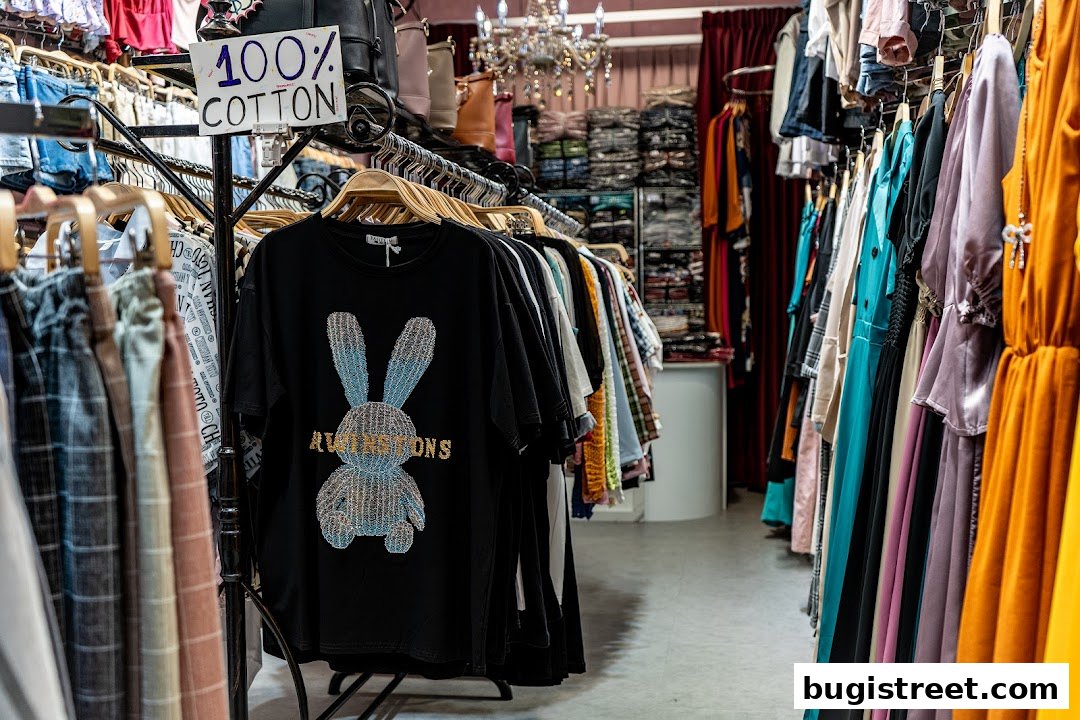 A boutique interior showcasing a variety of women's clothing, including dresses and t-shirts.