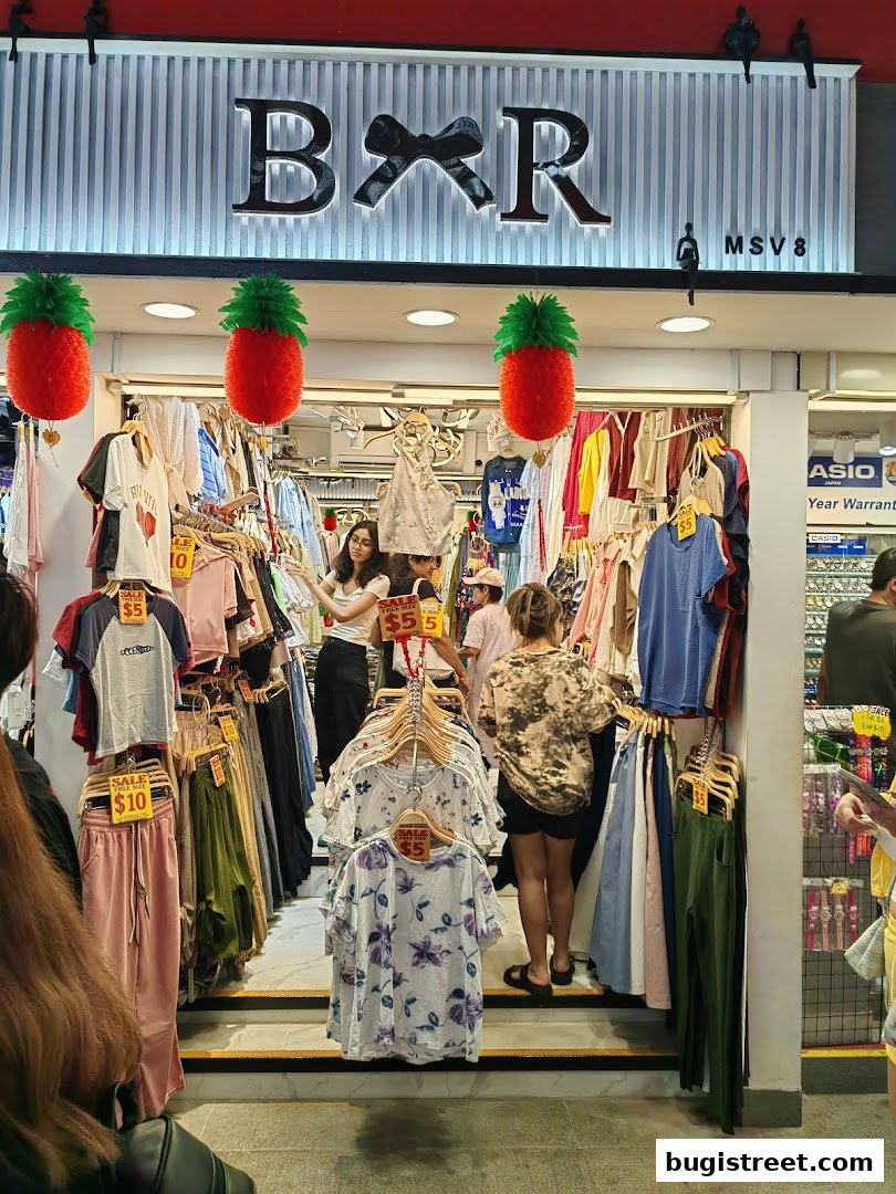 A boutique shop displaying a variety of clothing items and sale signs.