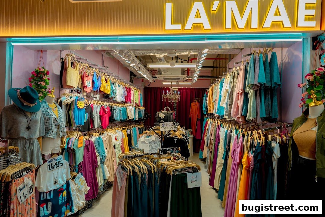 A boutique shop interior filled with colorful women's clothing on racks and mannequins.