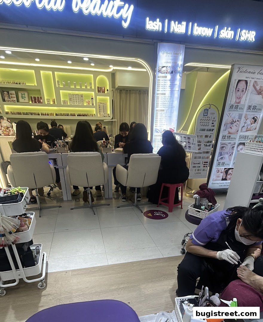 Interior of a nail salon with customers receiving manicures and pedicures.