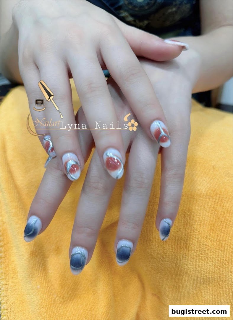 Close-up of hands with beautifully designed nails featuring abstract art and ombre effects.