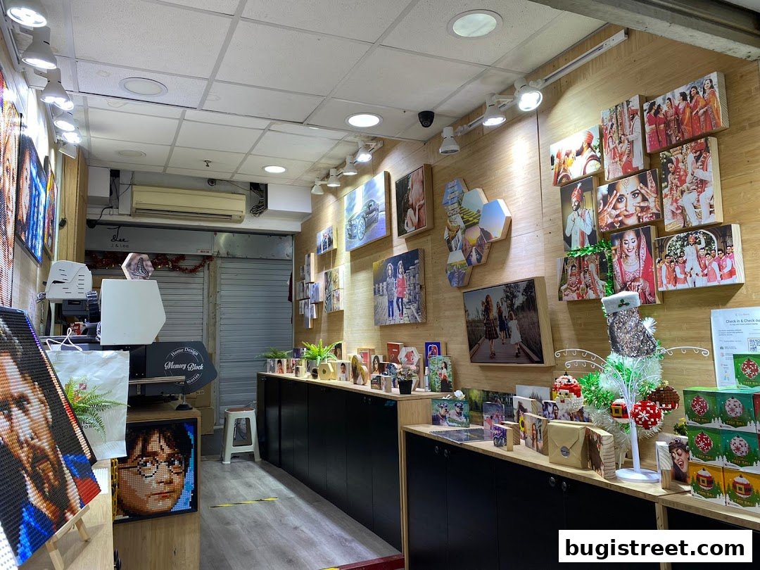 Interior of a shop displaying custom photo blocks and artwork, including portraits and wedding photos.