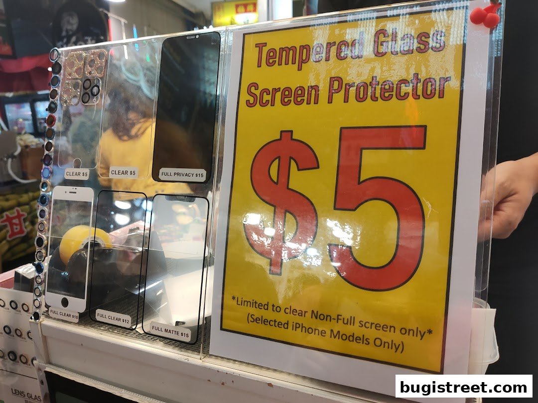 A display of various phone screen protectors with prices and a prominent $5 offer.