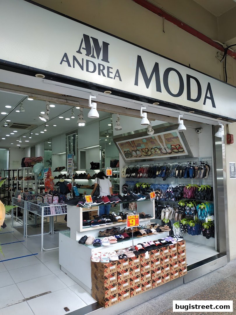 Moda Boutique shop front displaying a wide variety of footwear, including sandals and sneakers.