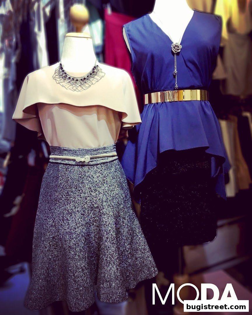 Two mannequins display stylish outfits from Moda Boutique, showcasing fashion-forward designs.