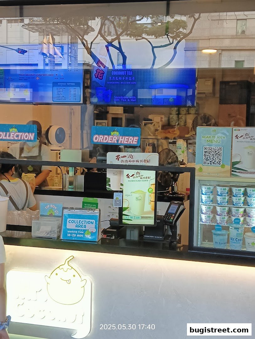 Mr. Coconut shop counter with menu displays, ordering signs, and chilled coconut products.