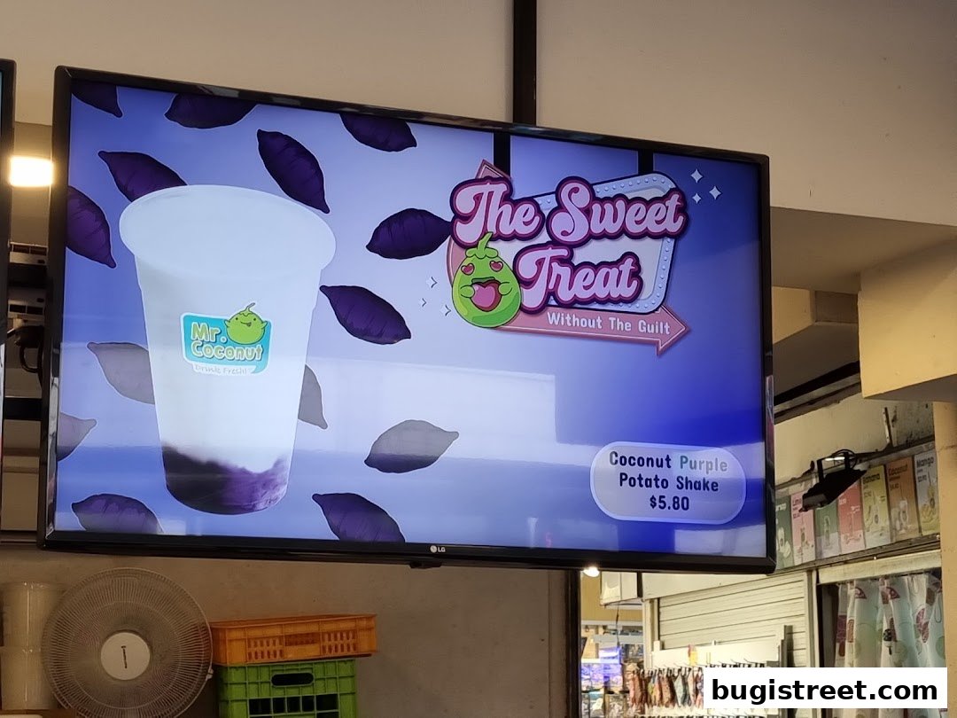 A digital screen displays a Coconut Purple Potato Shake from Mr. Coconut.
