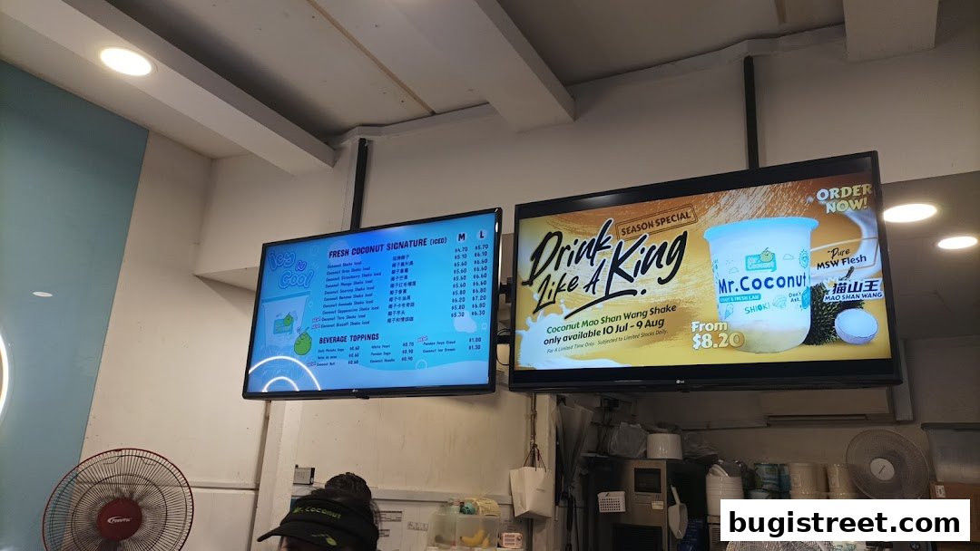 Digital menus displaying fresh coconut drinks and a special durian shake.