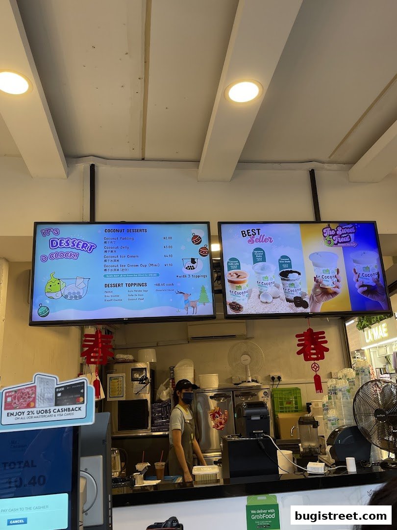 A menu board displays coconut desserts and toppings at Mr. Coconut.