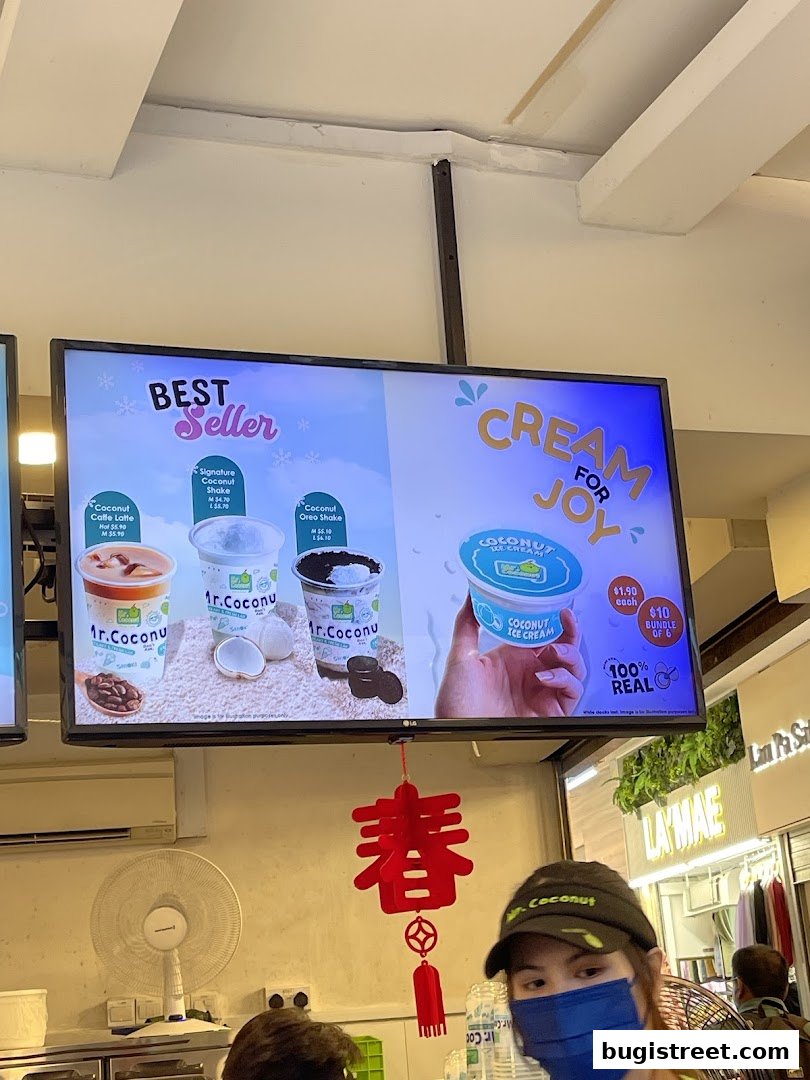 A digital menu board displaying Mr. Coconut's best-selling shakes and ice cream.