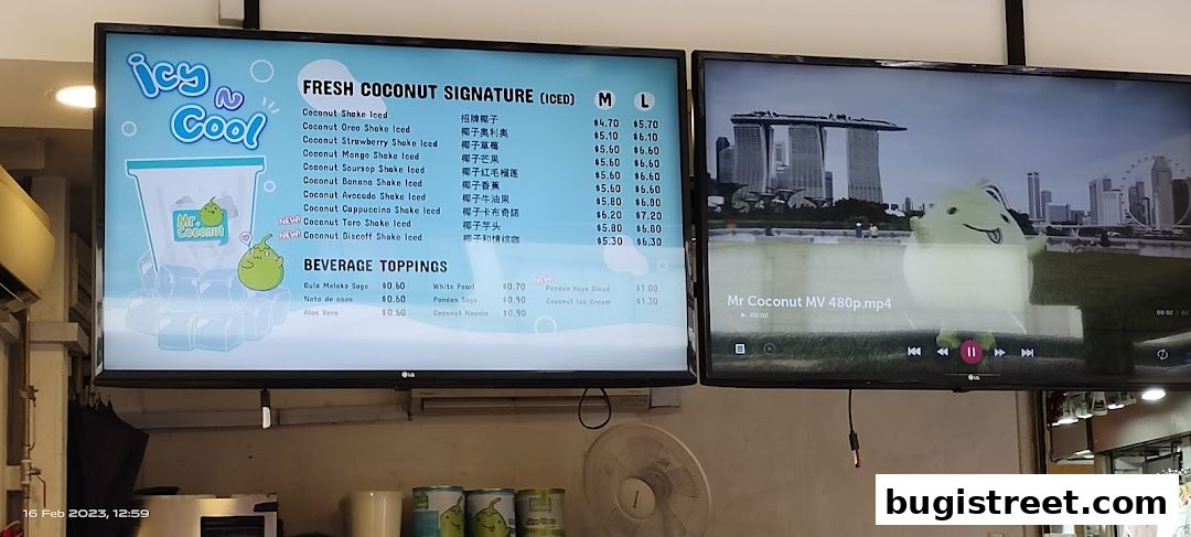 A digital menu board displaying fresh coconut signature drinks and beverage toppings.