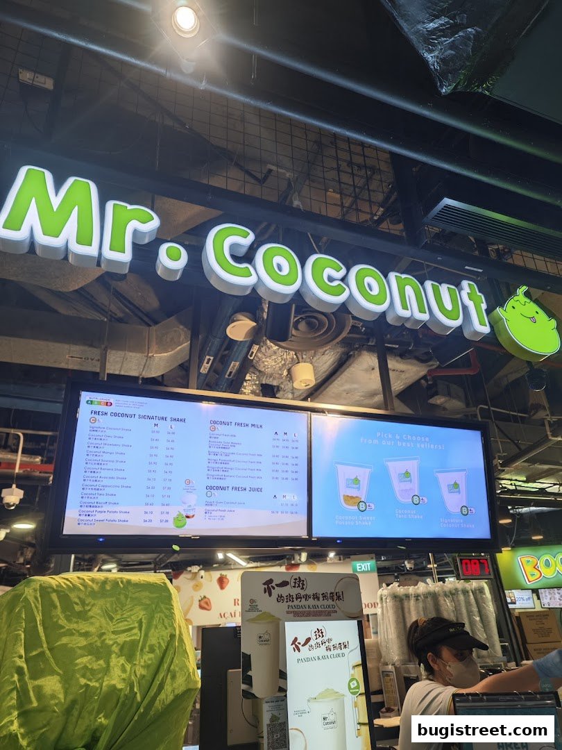 Mr. Coconut shop front with a digital menu displaying various coconut shakes and drinks.